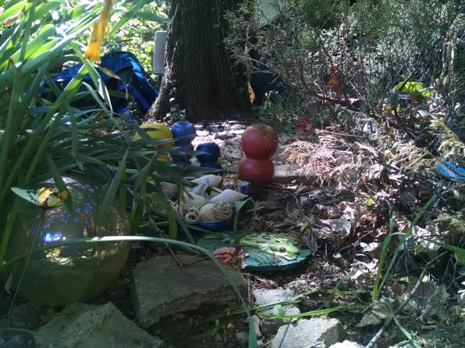 recycled pomegranate juice bottles ; painted; backyard garden art