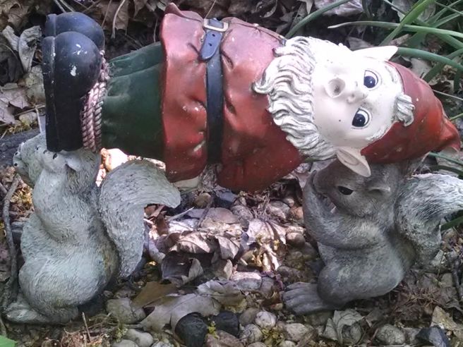 statue of squirrels carrying away garden gnome